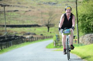 Woman cycling along the Greenways of Le Gers through the scenic Gascon countryside. Woman cycling along the Greenways of Le Gers through the scenic Gascon countryside.