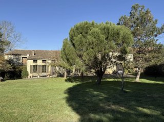 Countryside property in Occitanie surrounded by vineyards and rolling hills in southern France