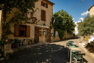 Traditional village café in Occitanie, southern France, where residents gather for coffee and meals, illustrating everyday living and lifestyle costs in the region