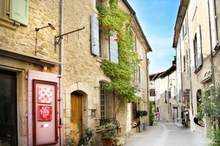 Quiet street in Saint-Lizier with stone houses, greenery, and traditional village atmosphere in Ariège Quiet street in Saint-Lizier with stone houses, greenery, and traditional village atmosphere in Ariège