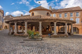 Medieval architecture and ancient stone buildings in a historic bastide town in the Gascony region of Southwest France. Medieval architecture and ancient stone buildings in a historic bastide town in the Gascony region of Southwest France.